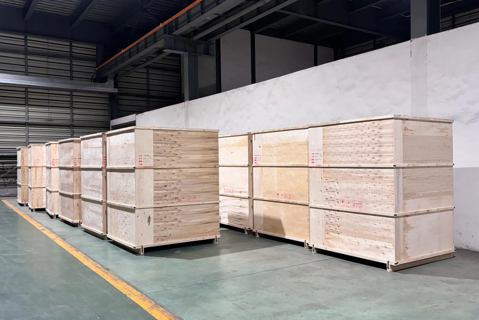 Export crates for the 30 boilers, and the crated units loaded on one of the three trucks.