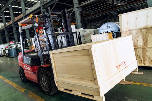 Export crates loaded by forklift for shipment.
