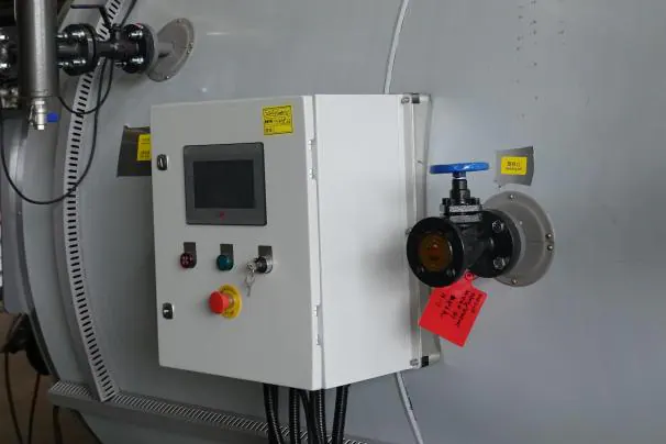 Boiler control panel with touch screen and emergency stop.
