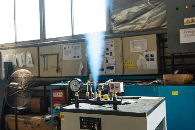 An electric steam generator releasing steam during a factory test.