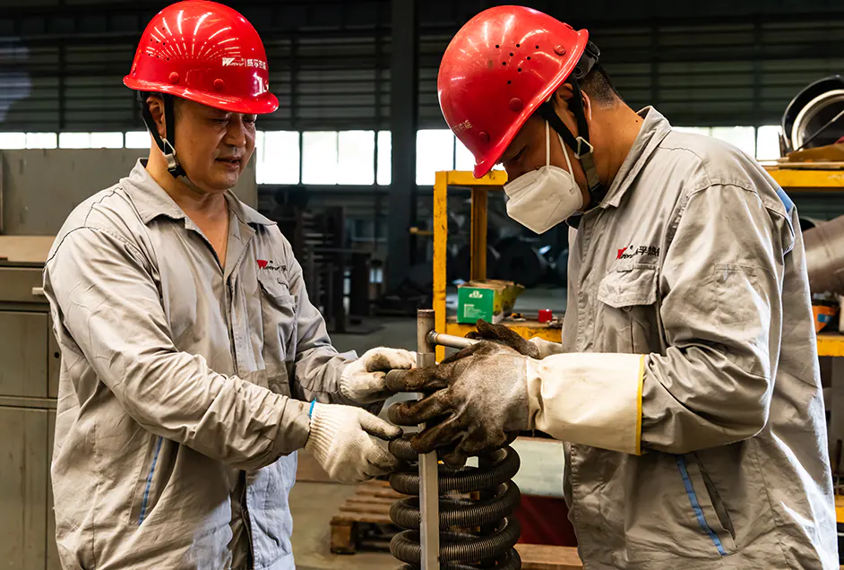 Fitters assembling a heating coil